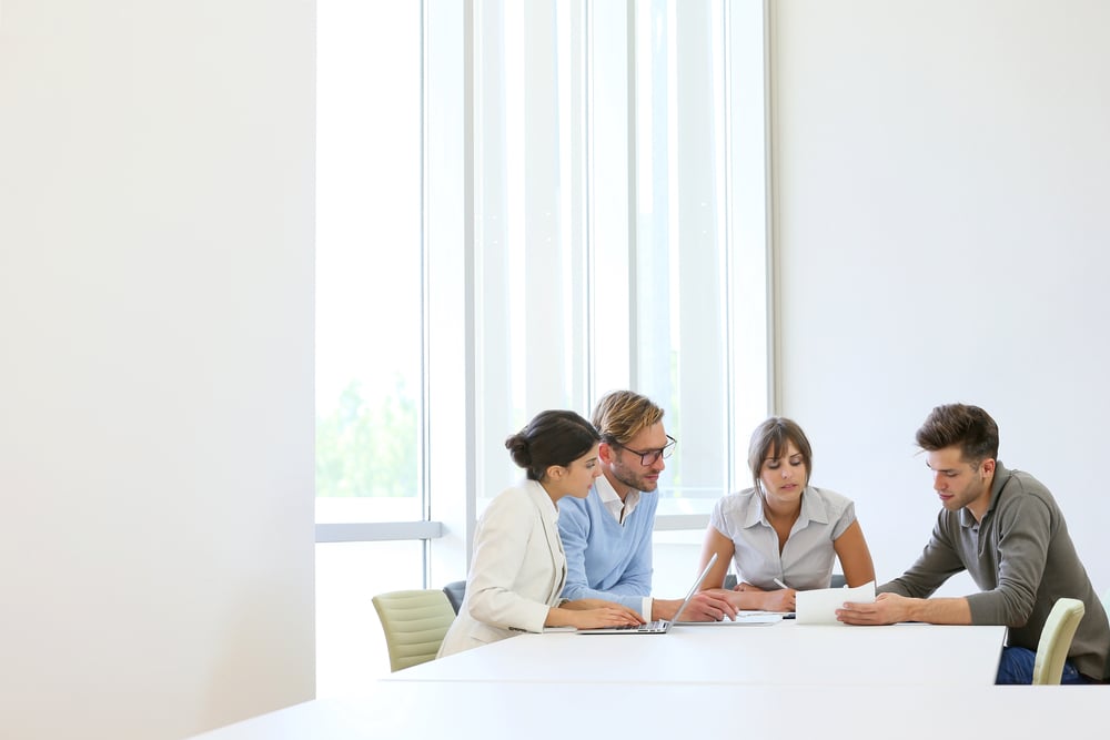 Business people meeting around table in modern space Business people meeting around table in modern space